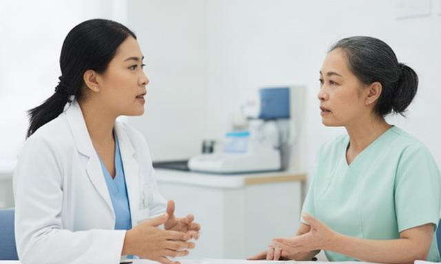 Petugas klinik pratama berbicara dengan pasien di ruang layanan yang terang
